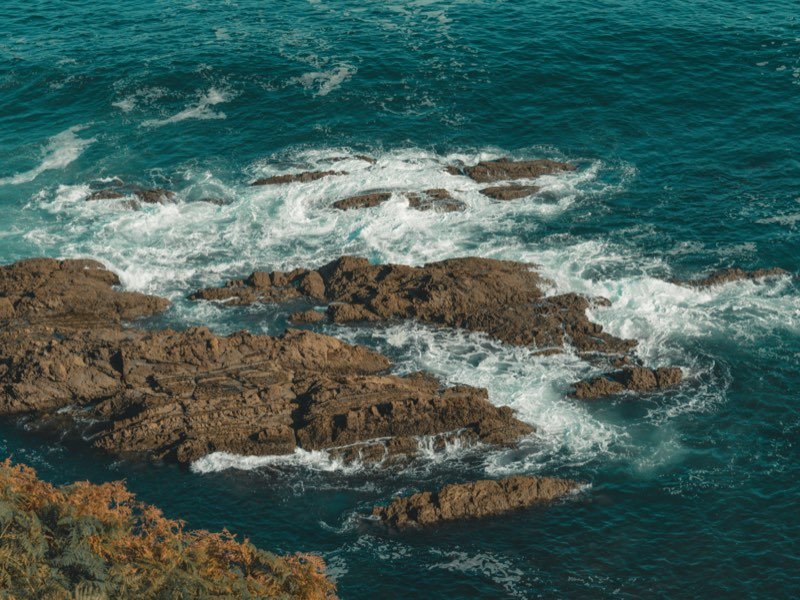 Olas rompiendo sobre las rocas de la costa